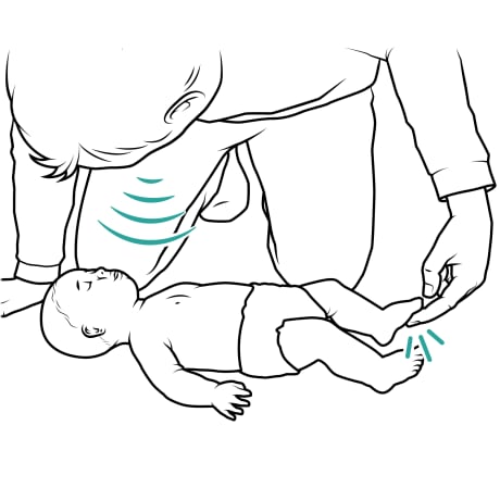 Person kneeling over baby lying on floor, with person shouting baby's name and tapping baby's foot. 