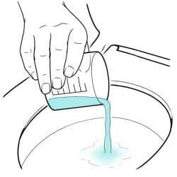 Pouring fluid from measuring cup into toilet.