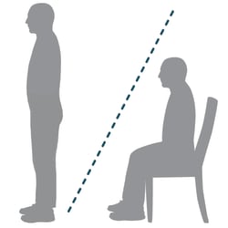 Person standing and person sitting in chair.