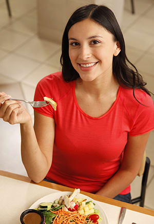 Female eating salad.