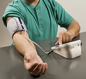 Male taking his blood pressure at home. 