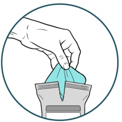 Hand pulling new wipe out of package.