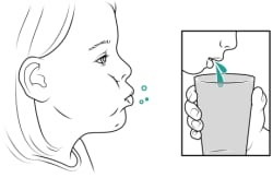 Child rinsing mouth and spitting into cup.
