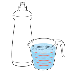Bottle of liquid soap next to measuring cup of water.