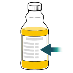 Bottle of orange juice with arrow pointing to nutritional values on label.