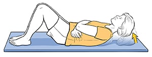 Woman lying on back doing stomach strengthening exercise.