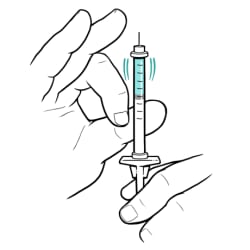 With insulin bottle removed and needle filled with insulin and still pointing up, finger flicking syringe.