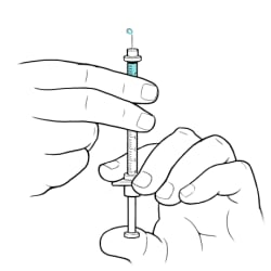 One hand holding syringe with needle pointing up and other hand pushing plunger with drop of insulin coming out from needle.