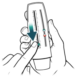 One hand holding peak flow meter and other hand sliding pointer down to bottom.