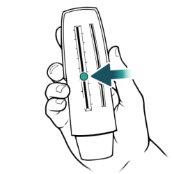 Hand holding peak flow meter, with arrow on pointer.