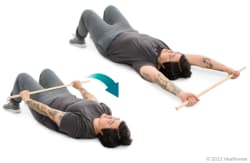 Shoulder extensor stretch (lying down, with wand)