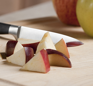 Person cutting up fruit.