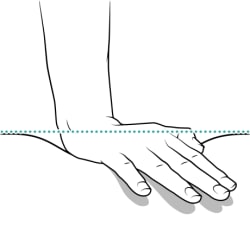 Close-up of hand pushing down on baby’s chest, with the approximate depth shown with dotted line.