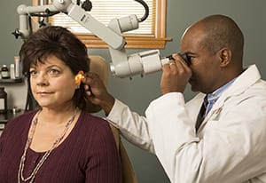 Doctor examining patient's ear.