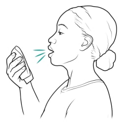 Person coughing into tissue.